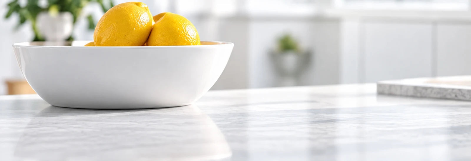 Bowl of lemons on a bright kitchen counter