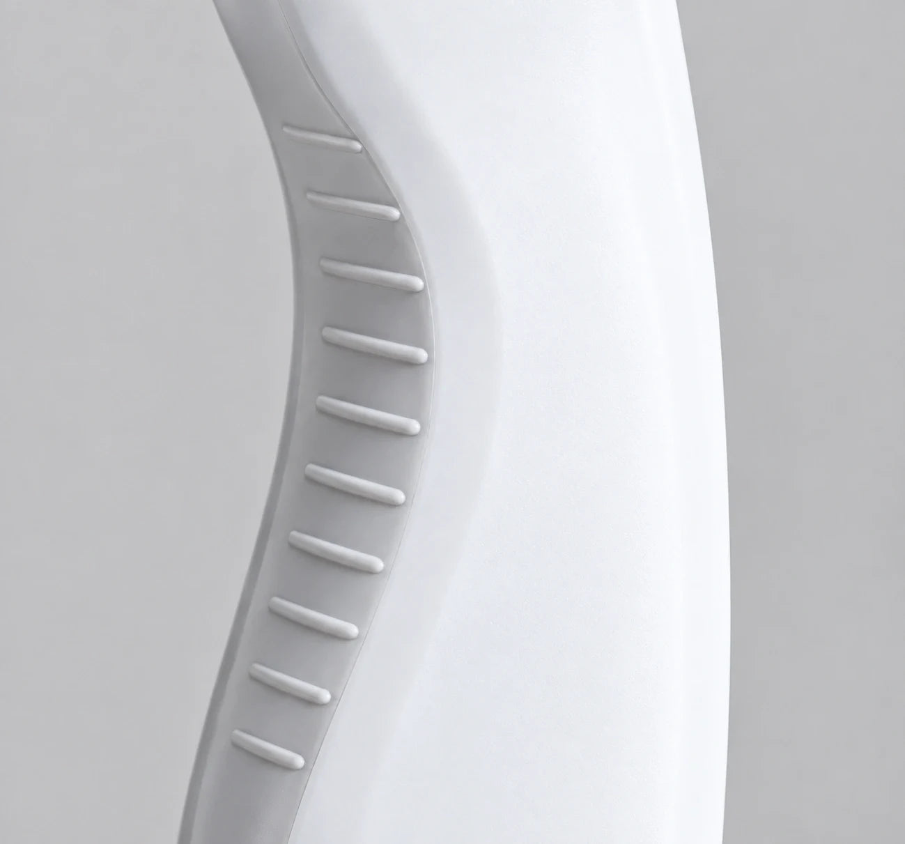 Curved handle of the white bottle