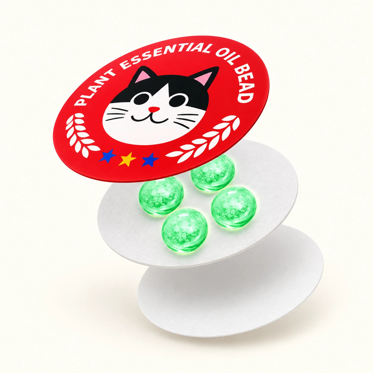 Conceptual exploded structure showing a red printed cat face, four green beads on a white carrier, and a white backing layer